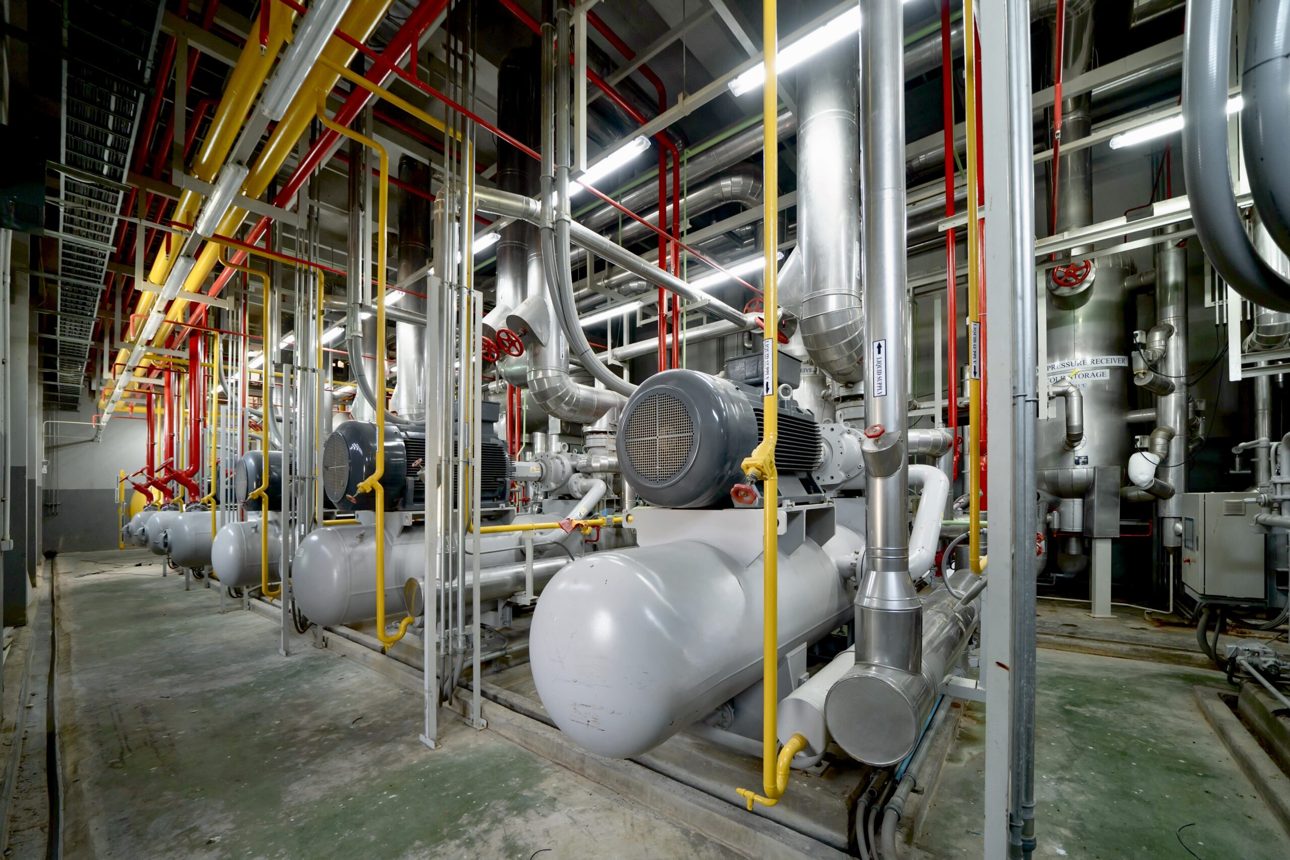 Inside of Industry factory. Chiller tower or cooling tower in building. System work machine. Condenser Water Supply and return pipe lines. Ventilation compressor. Water system in workshop.